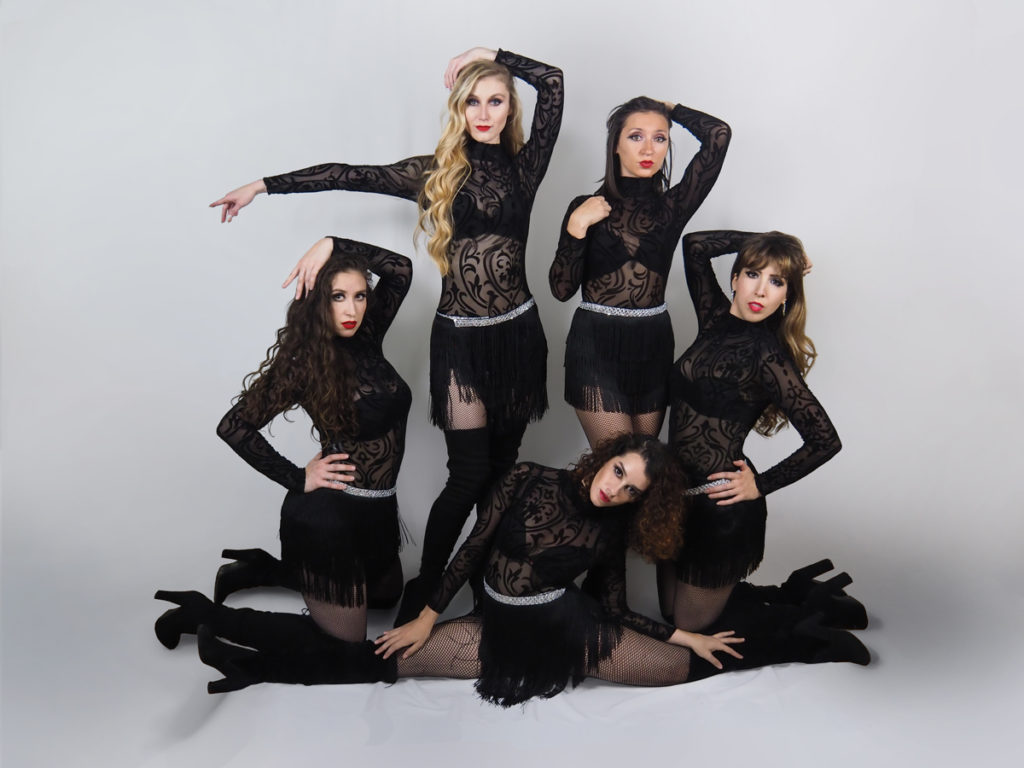 Jazz dancers in black leotards.